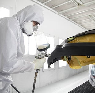 Collision Center Technician Painting a Vehicle | Fitzgerald Toyota Gaithersburg in Gaithersburg MD